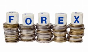 Stacks of coins with the word FOREX isolated on white background